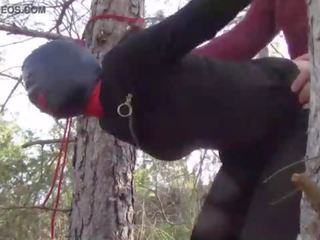 Tied up to a tree outdoor on flirty clothes&comma; wearing pantyhose and high ankle boots heels&comma; rough fuck