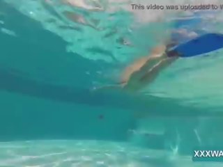 Superior brunette escort Candy swims underwater